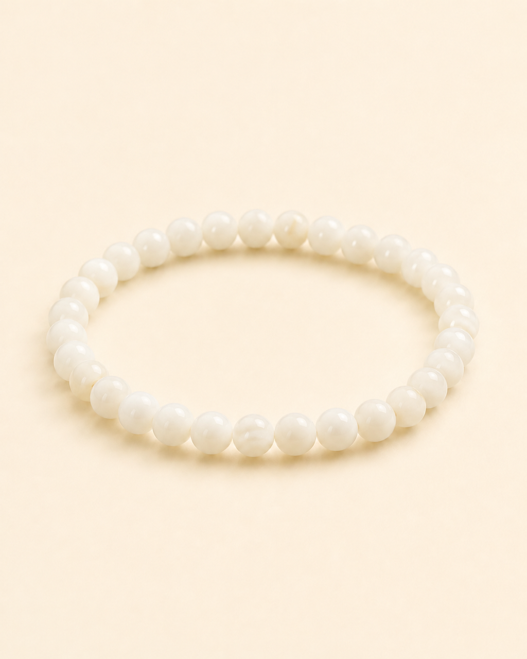 Styled view of Soft Tide White Shell Bracelet by AURAM with white shell beads for coastal layering
