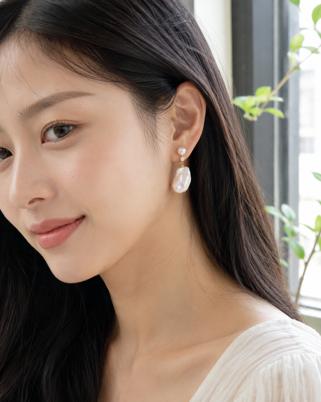 Detail view of Moon Tide Baroque Pearl Earrings by AURAM with moon-inspired baroque pearl detail