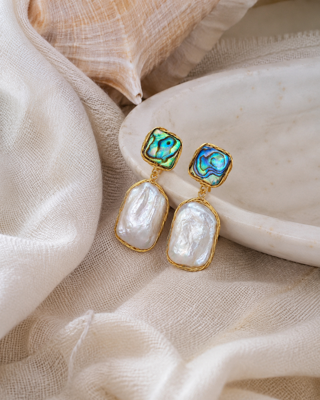 Styled view of Ocean Aura Baroque Pearl Earrings by AURAM with natural pearl glow and coastal styling