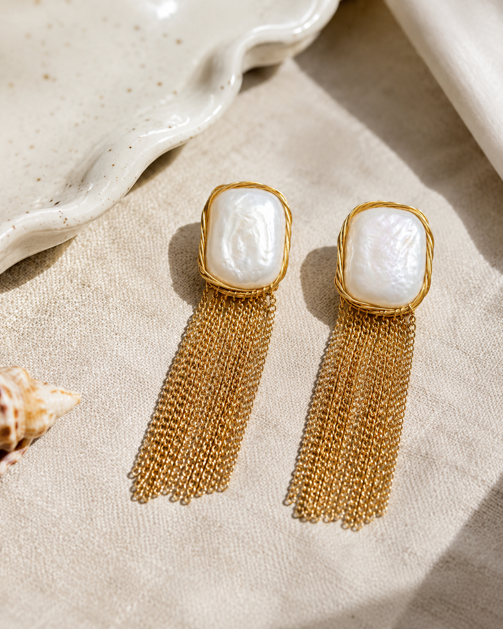 Styled view of Falling Light Baroque Pearl Tassel Earrings by AURAM with organic pearl drops