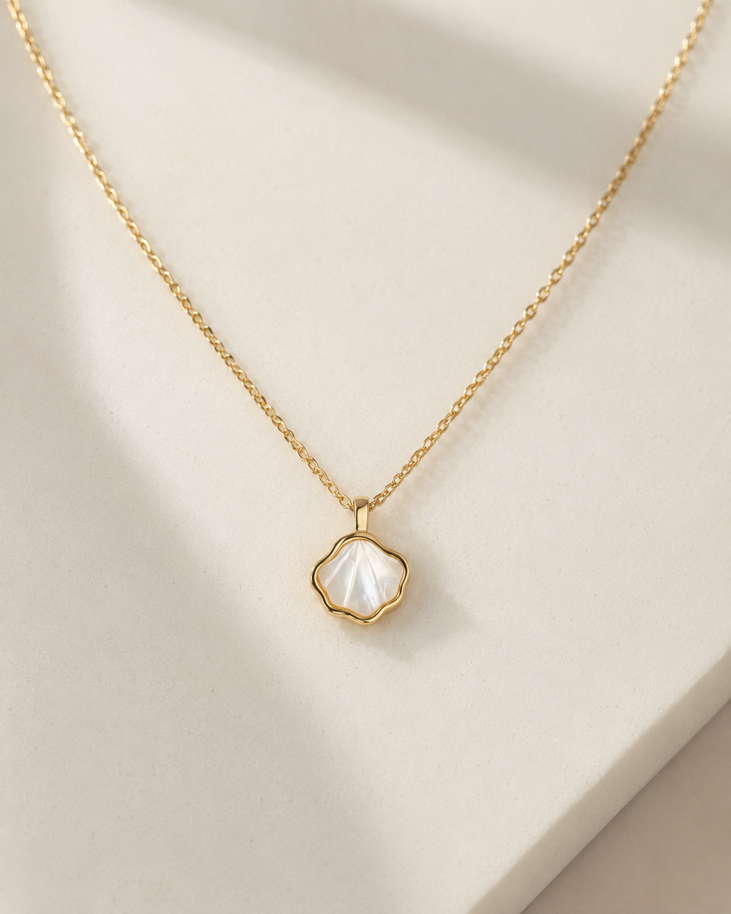 Styled view of Shell Bloom Mother-of-Pearl Pendant Necklace by AURAM with floral shell-inspired pendant