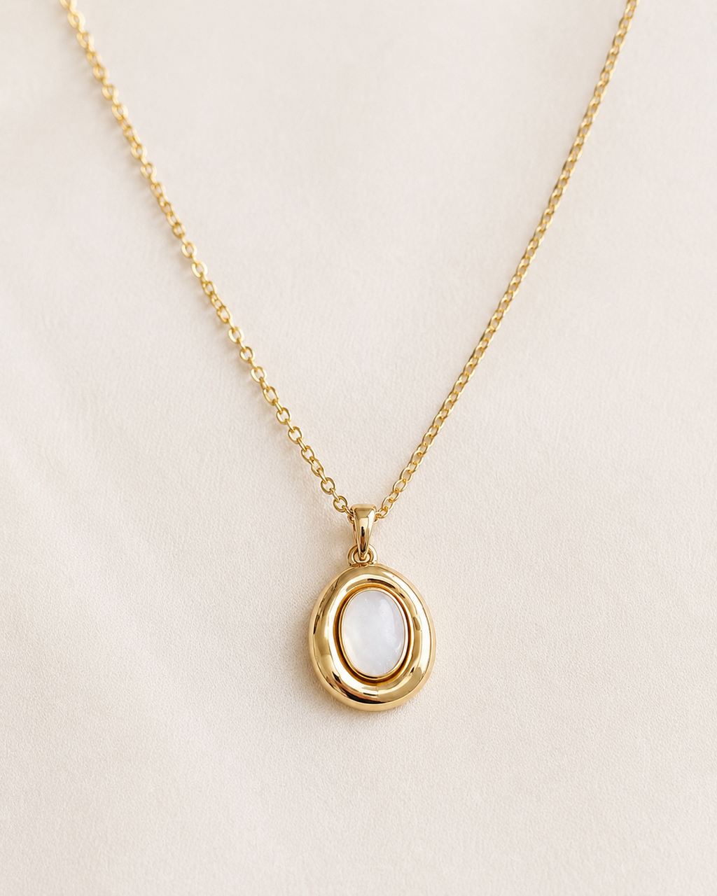 Styled view of Moon Cove Mother-of-Pearl Pendant Necklace by AURAM with moon-inspired shell pendant