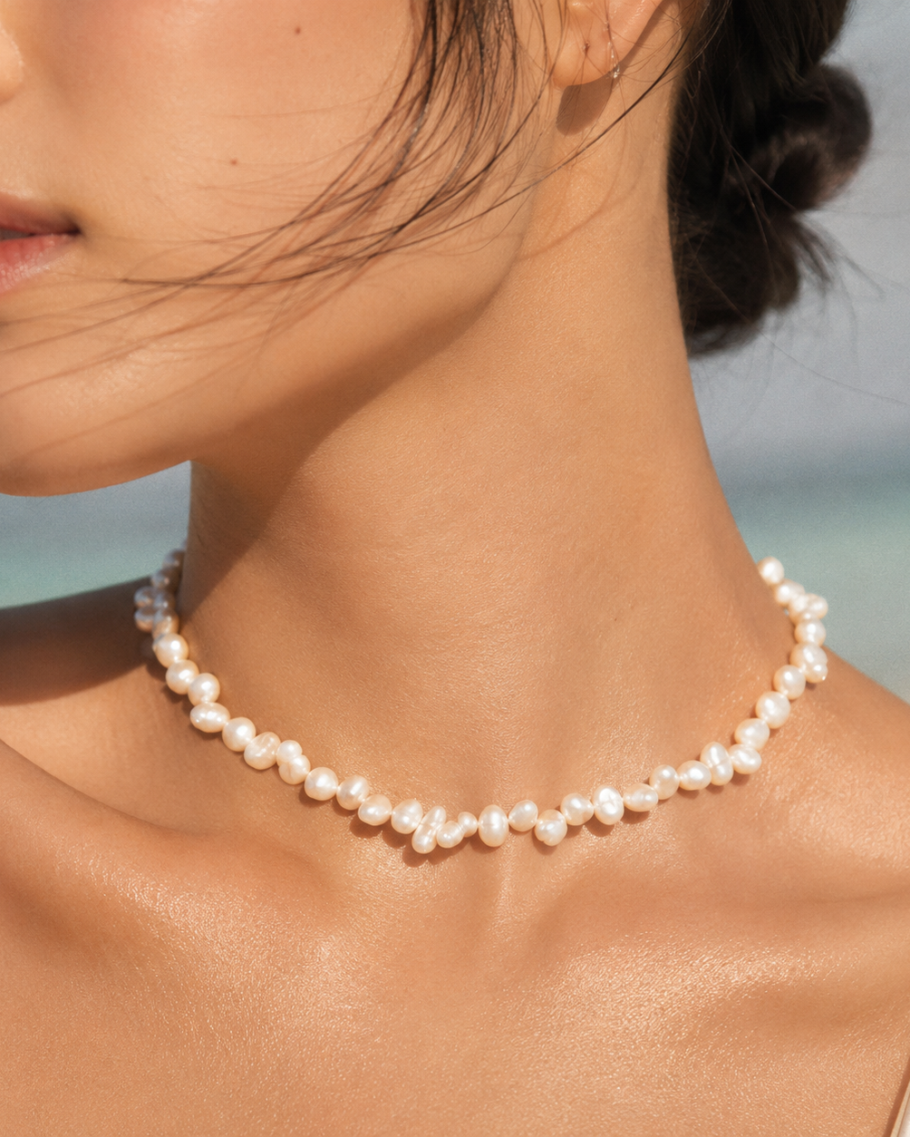 Alternate product view of Mini Baroque Pearl Choker by AURAM with small organic pearls for modern layering