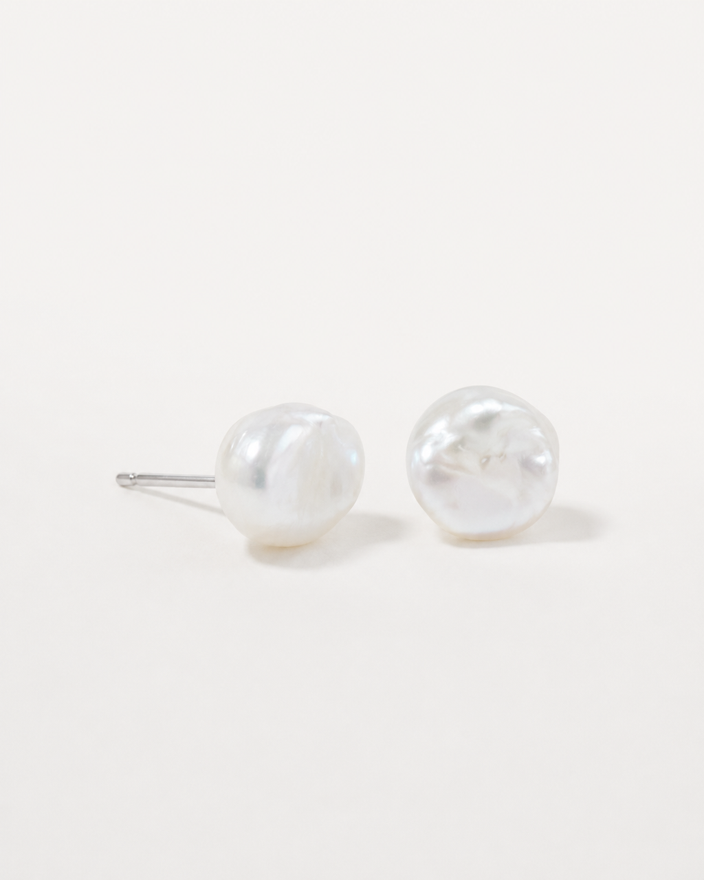 Detail view of Tiny Pearl Studs by AURAM, minimal everyday pearl stud earrings