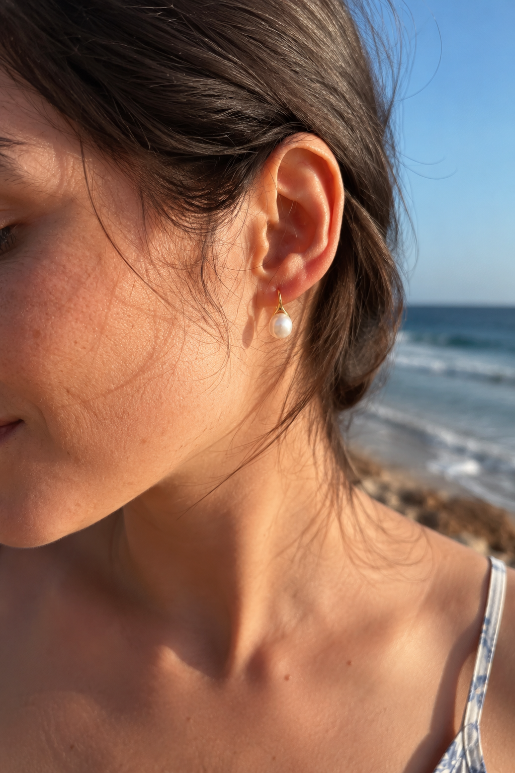 Detail view of Luna Curve Pearl Earrings by AURAM, modern pearl earrings with soft gold-tone curve styling