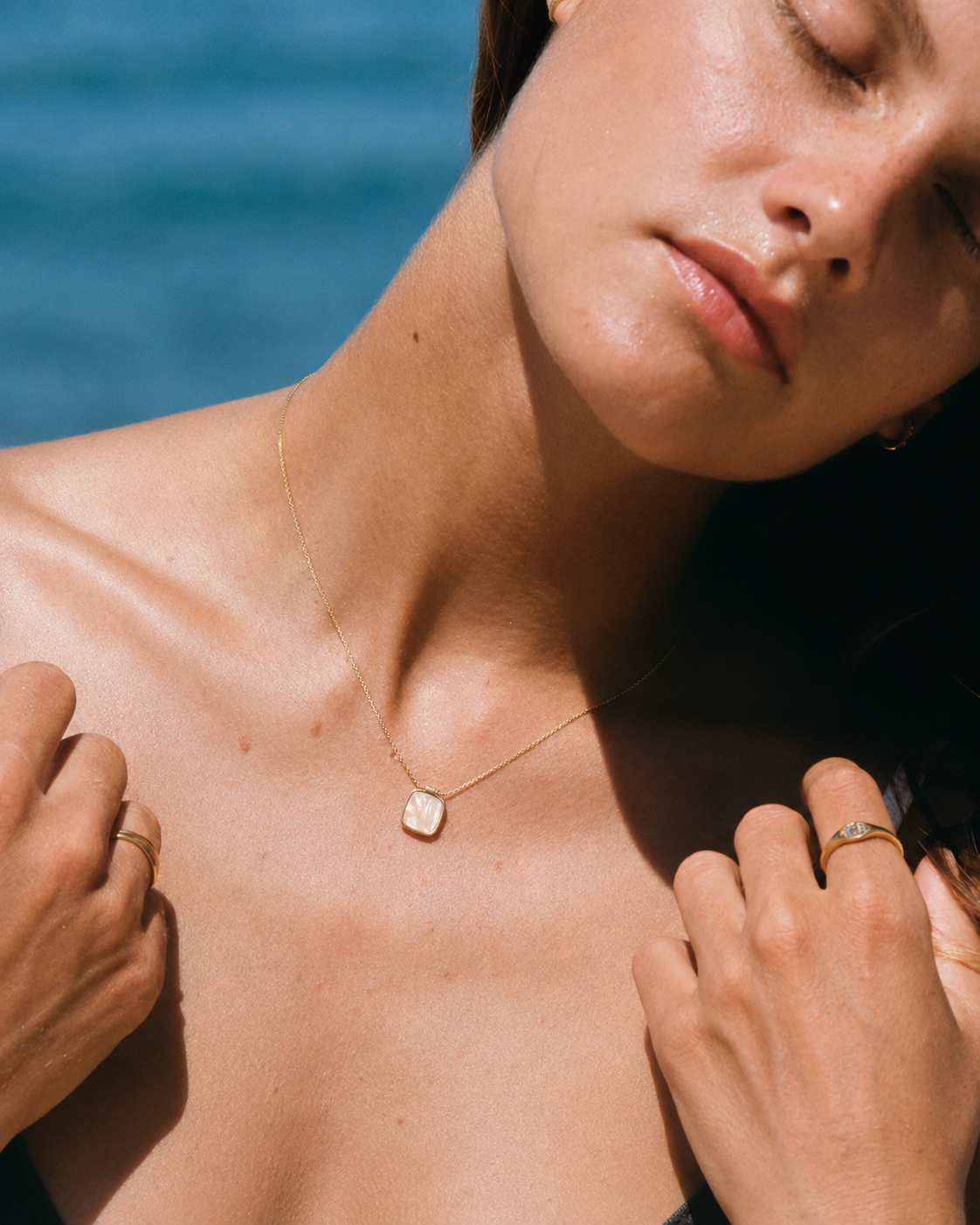 Alternate product view of Shell Glow Pendant Necklace by AURAM with luminous shell-style pendant and gold-tone chain