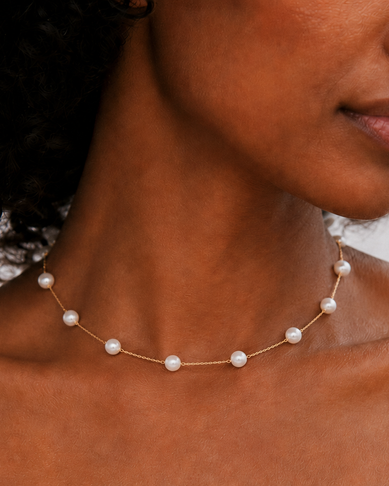 Styled view of Baroque Pearl Station Necklace by AURAM with organic pearl stations for layering