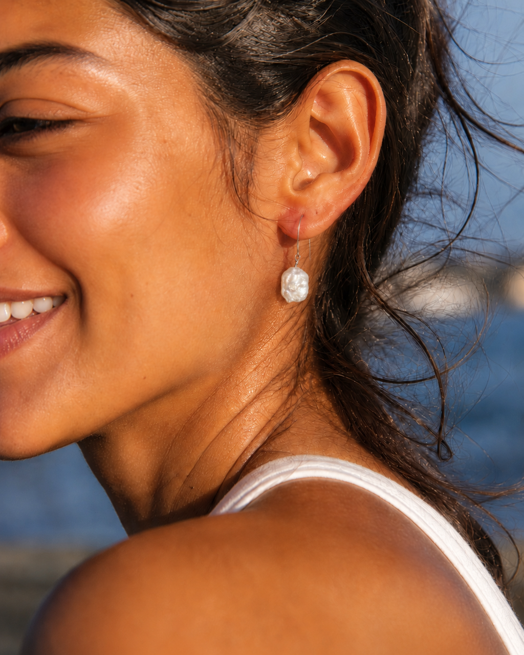 Detail view of Crescent Pearl Earrings by AURAM with moon-inspired pearl styling